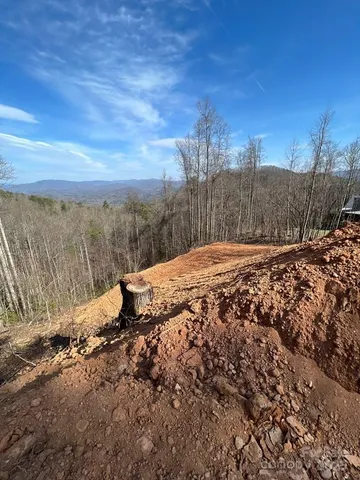 a view of a dry yard with mountains in the background