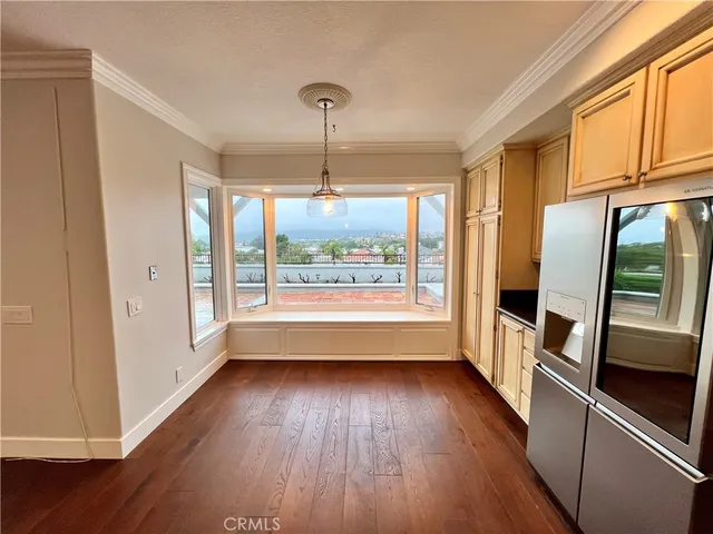 a view of hallway with wooden floor and window
