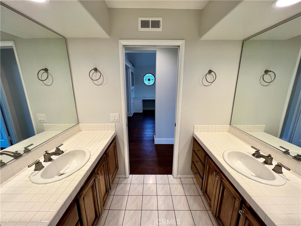 15 Larkfield Lane Laguna Niguel, CA 92677 - Photo 27 of 55 a bathroom with a sink vanity and mirror