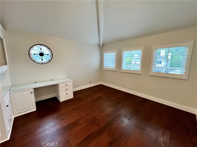 a view of a hallway with wooden floor and stairs