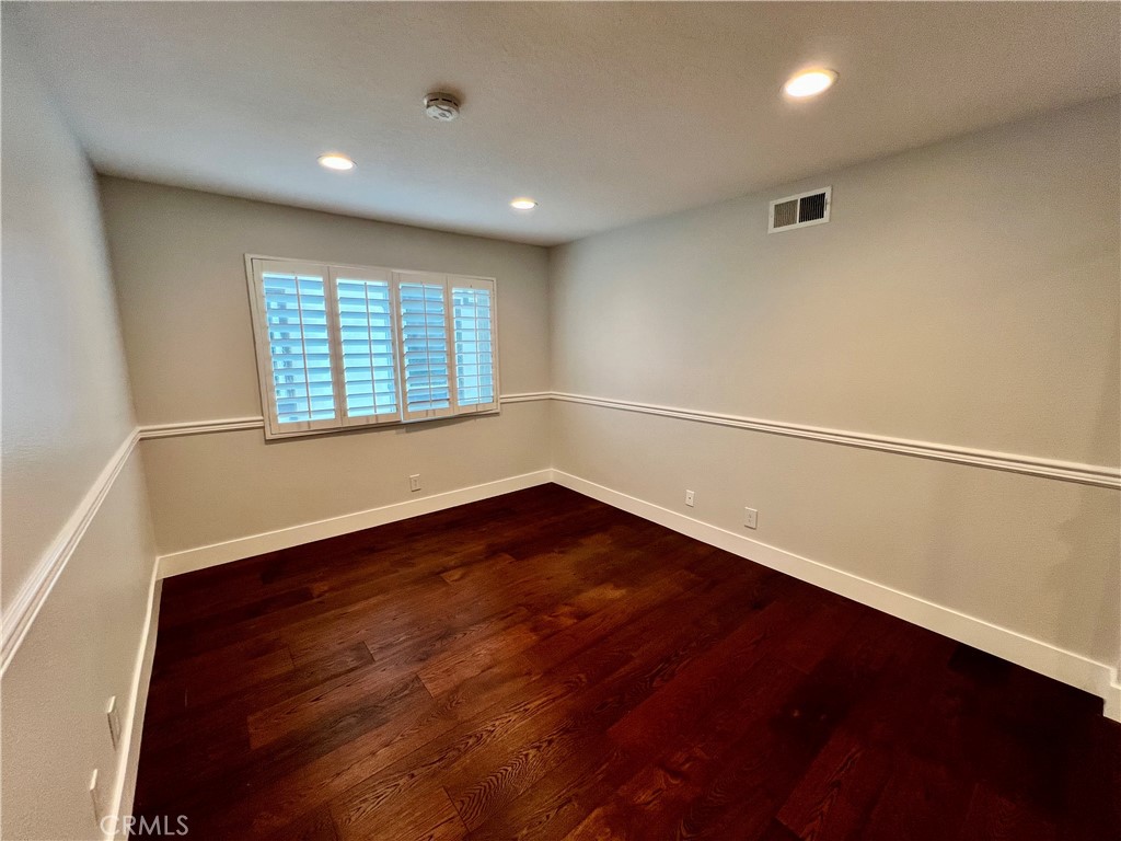 15 Larkfield Lane Laguna Niguel, CA 92677 - Photo 33 of 55 an empty room with wooden floor and windows