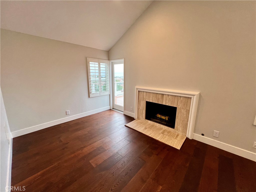 15 Larkfield Lane Laguna Niguel, CA 92677 - Photo 38 of 55 an empty room with wooden floor and fireplace