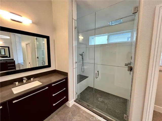 a spacious bathroom with a double vanity sink and a mirror