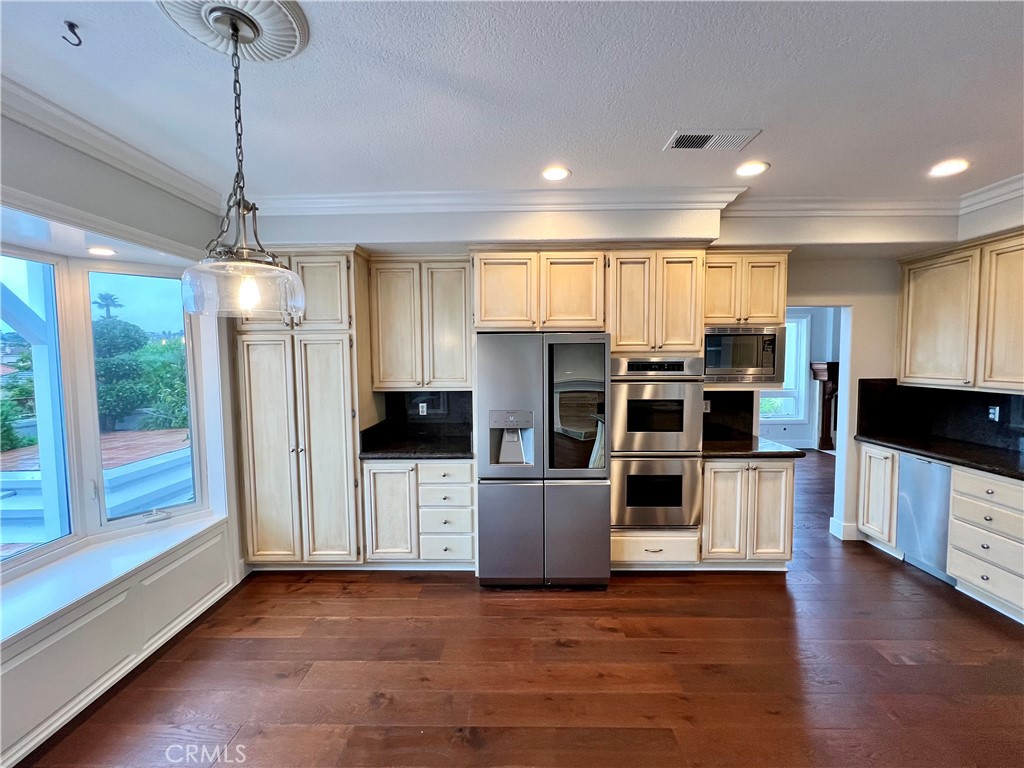 15 Larkfield Lane Laguna Niguel, CA 92677 - Photo 8 of 55 a view of a kitchen with stainless steel appliances wooden floor and window