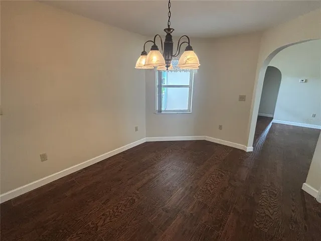a room with wooden floor and windows