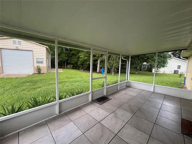 a view of a backyard with plants and porch