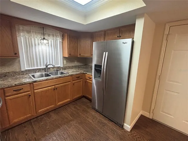 a kitchen with stainless steel appliances granite countertop a refrigerator and a sink