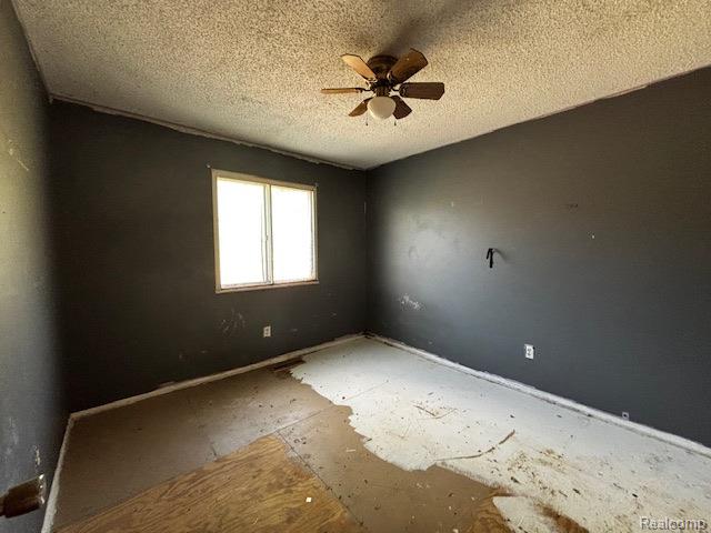 3901 West Lovejoy Road Byron, MI 48418 - Photo 9 of 19 Empty room with a textured ceiling and a ceiling fan