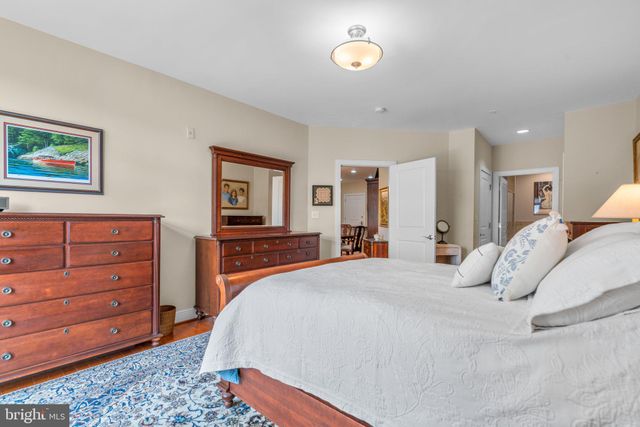 a bedroom with a large bed and a lamp next to a window