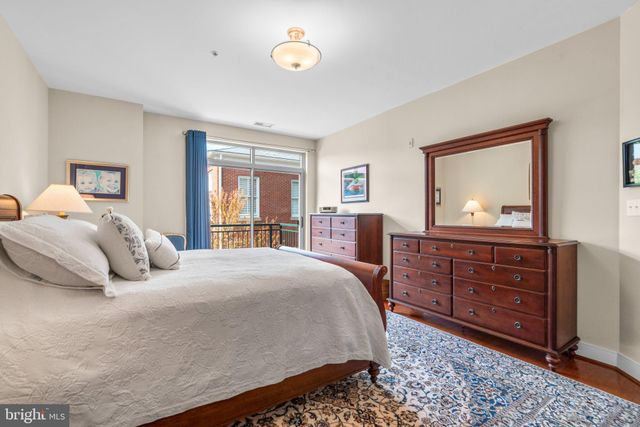 a bathroom with a granite countertop sink a toilet a mirror a bathtub and shower