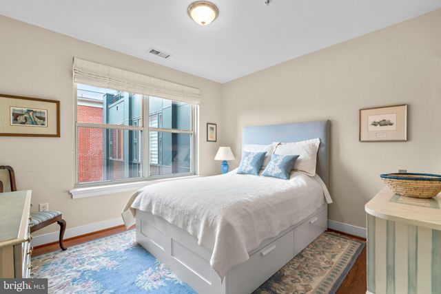 a bedroom with a bed and a desk