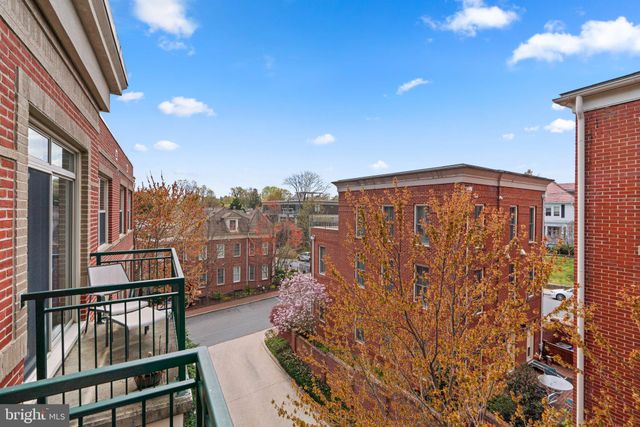 a living room with furniture a rug and a large window