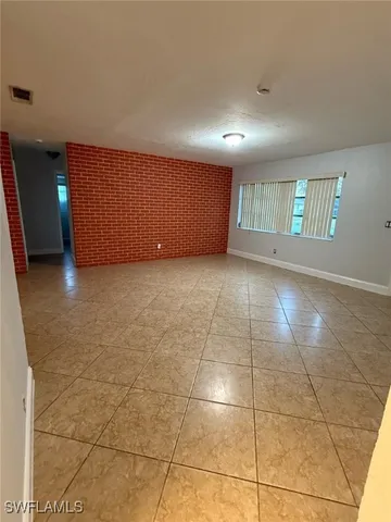 a view of a livingroom with a ceiling fan and window