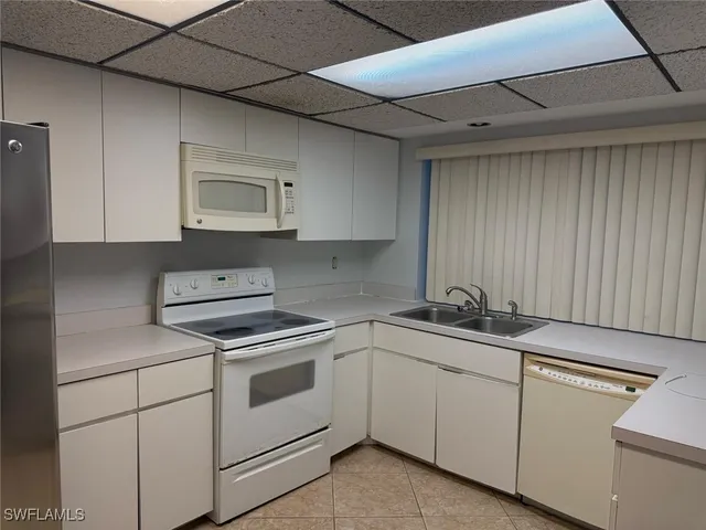 a view of cabinets a sink and dishwasher in a kitchen