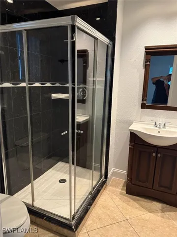 a kitchen with granite countertop white cabinets and stainless steel appliances
