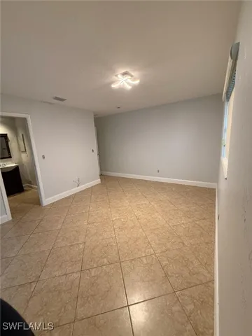 an empty room with a empty space and windows