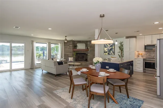 a dining room with furniture a chandelier and wooden floor