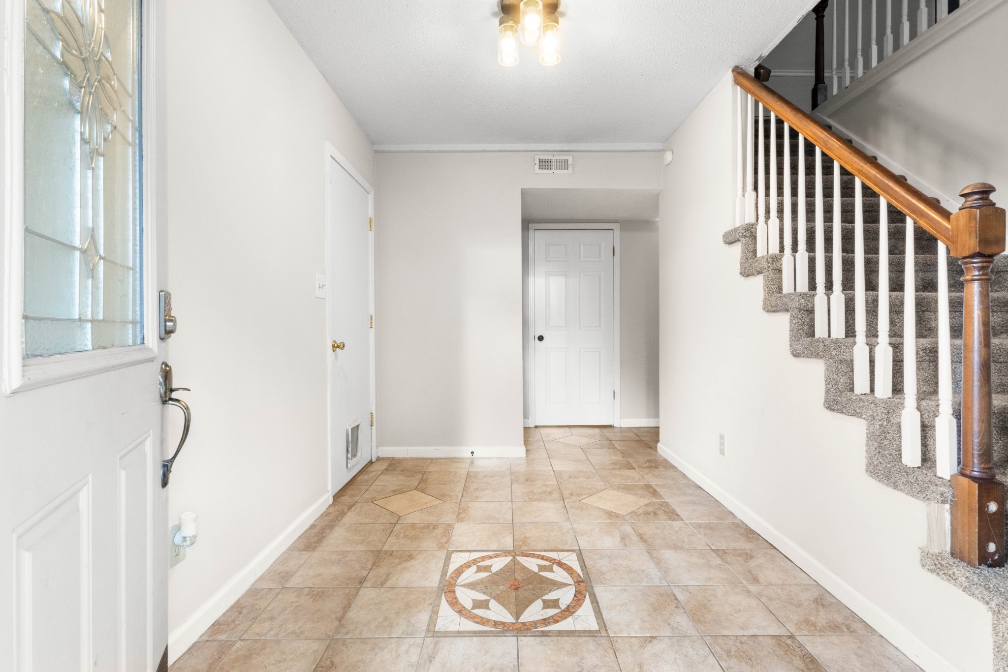 511 Sango Road Clarksville, TN 37043 - Photo 2 of 22 a view of a hallway with wooden floor and staircase
