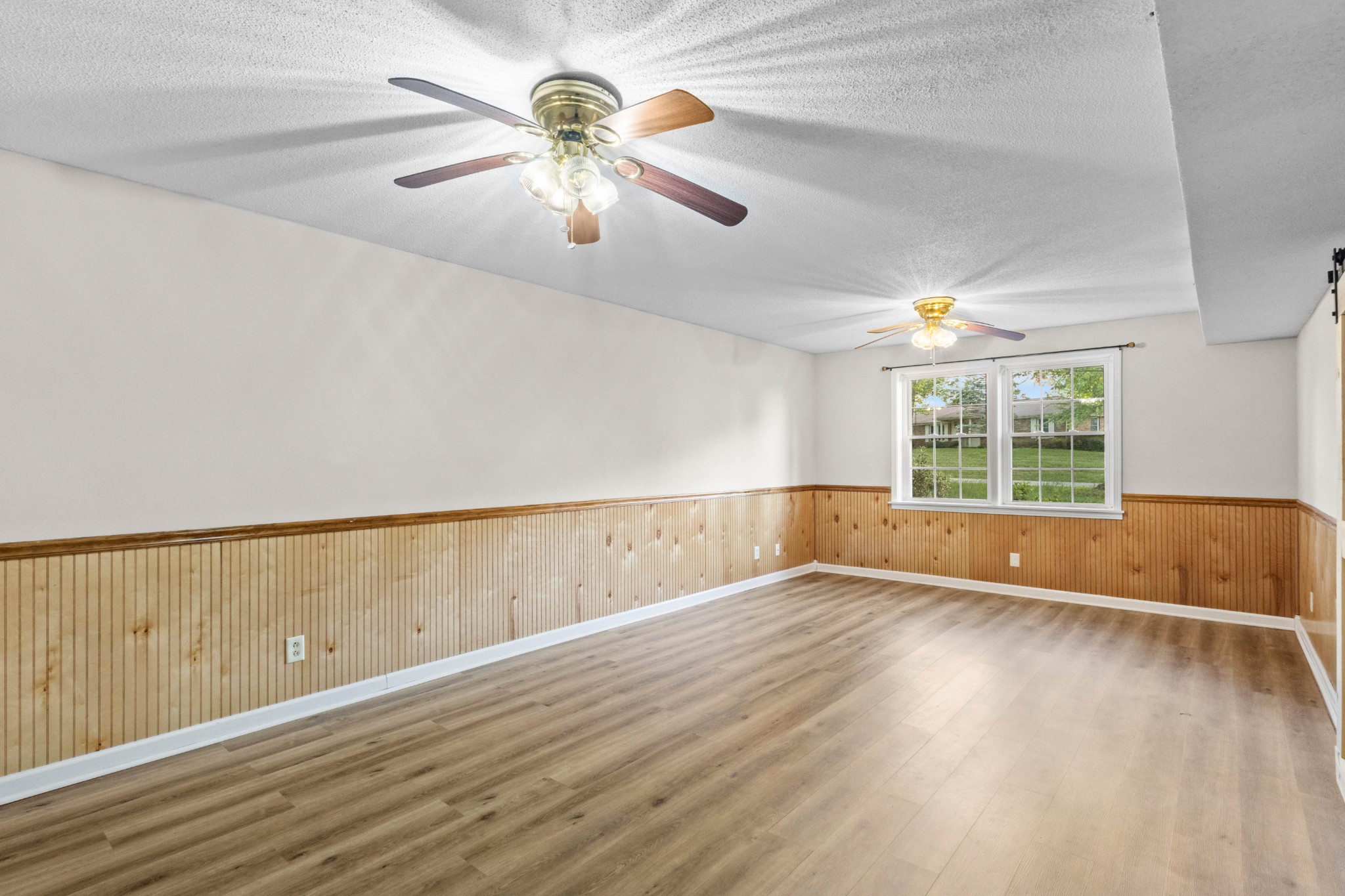 511 Sango Road Clarksville, TN 37043 - Photo 4 of 22 an empty room with wooden floor and windows