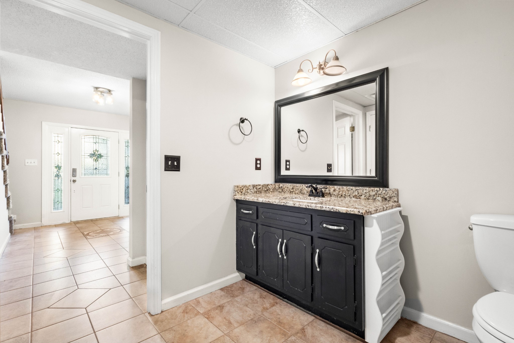 511 Sango Road Clarksville, TN 37043 - Photo 5 of 22 a bathroom with a granite countertop toilet sink and mirror