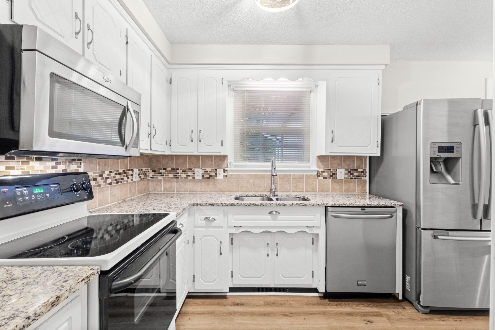 511 Sango Road Clarksville, TN 37043 - Photo 9 of 22 a kitchen with a stove a sink and a refrigerator