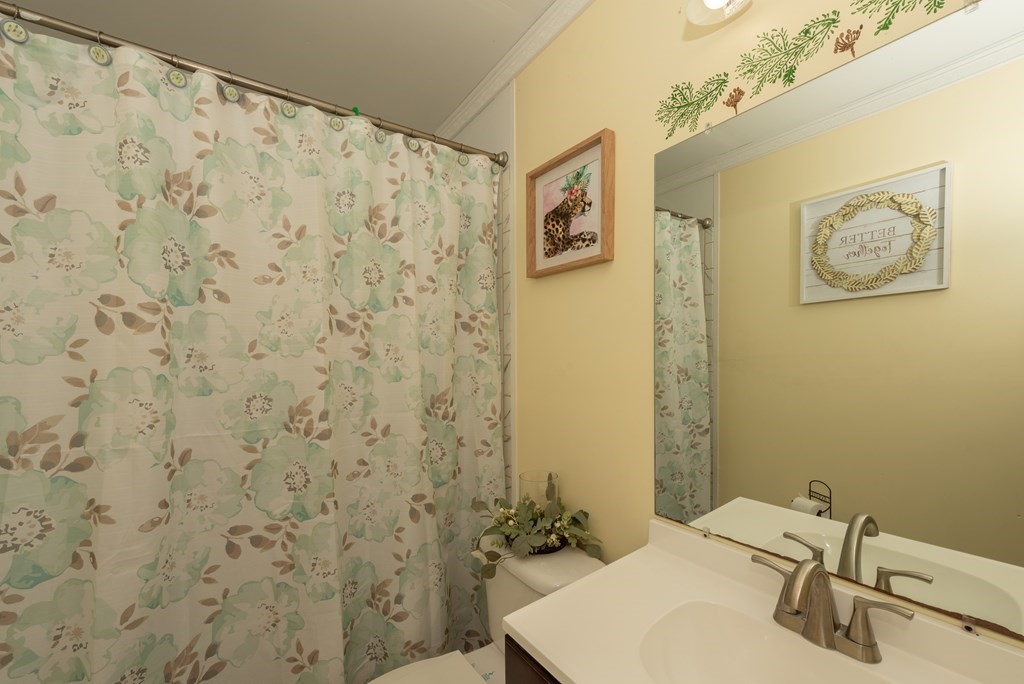 90 Anawan Street Rehoboth, MA 02769 - Photo 13 of 24 a bathroom with a sink and a mirror