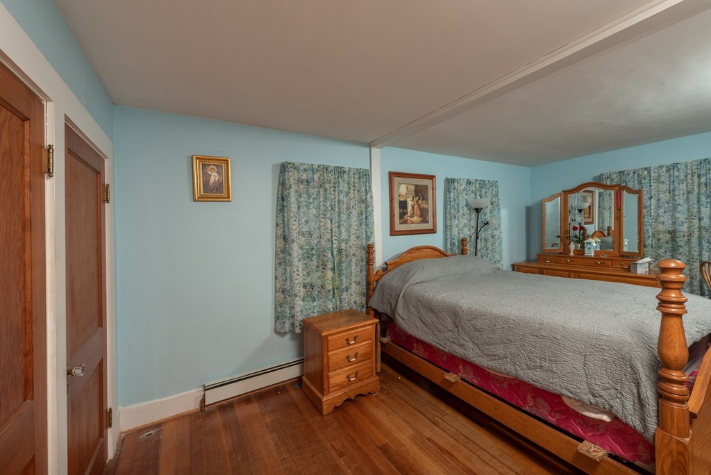 90 Anawan Street Rehoboth, MA 02769 - Photo 14 of 24 a bedroom with a bed and wooden floor