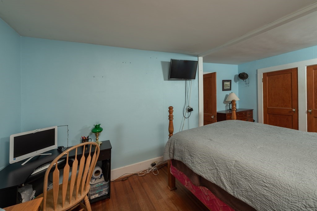 90 Anawan Street Rehoboth, MA 02769 - Photo 15 of 24 a bedroom with a bed and wooden floor