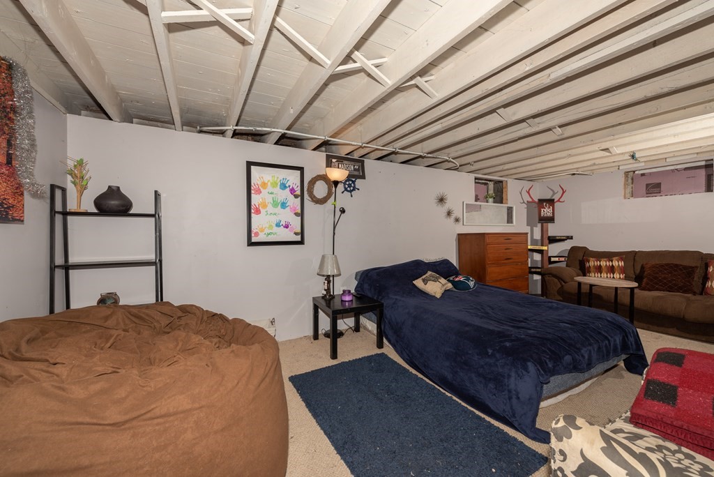 90 Anawan Street Rehoboth, MA 02769 - Photo 19 of 24 a bed room with a bed window and a chair