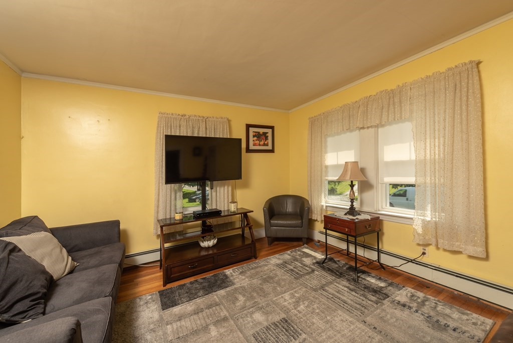 90 Anawan Street Rehoboth, MA 02769 - Photo 4 of 24 a living room with furniture and a flat screen tv
