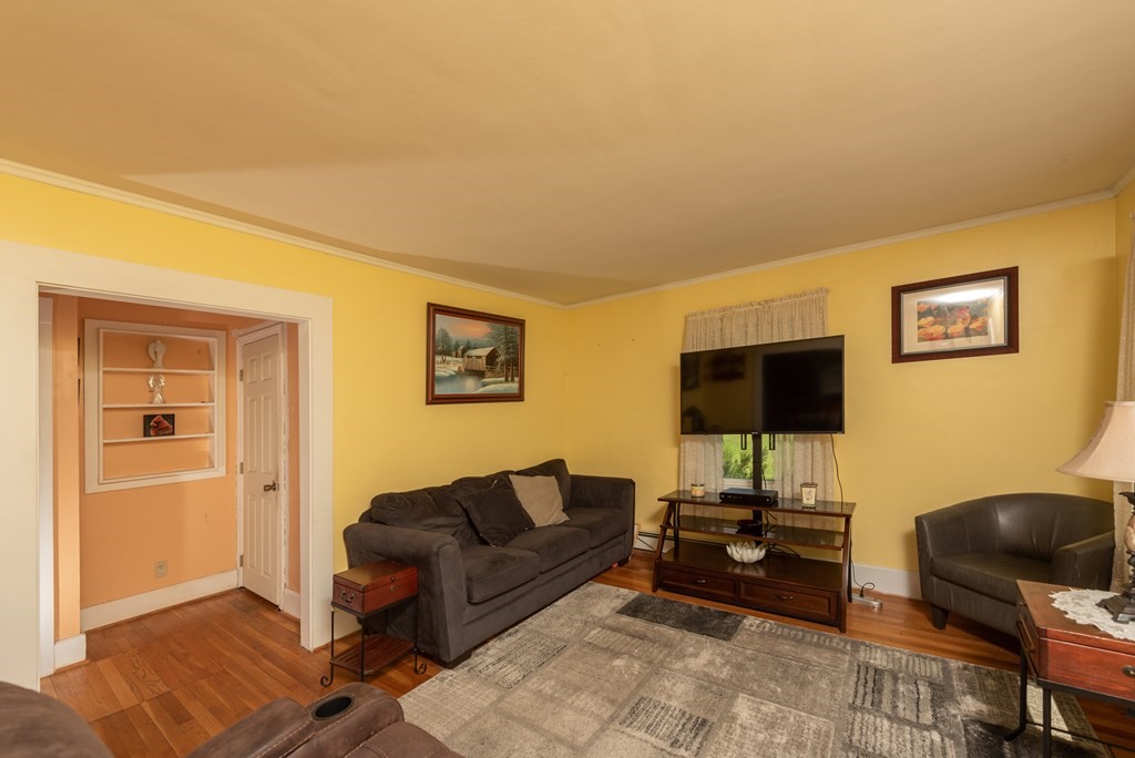 90 Anawan Street Rehoboth, MA 02769 - Photo 5 of 24 a living room with furniture and a flat screen tv