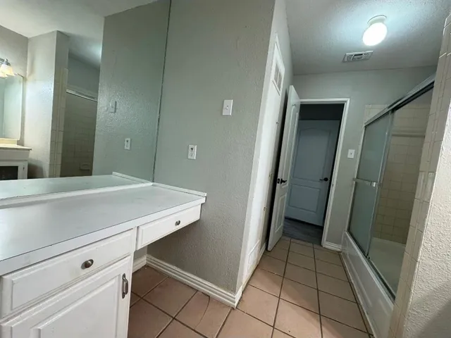 a bathroom with a glass shower door
