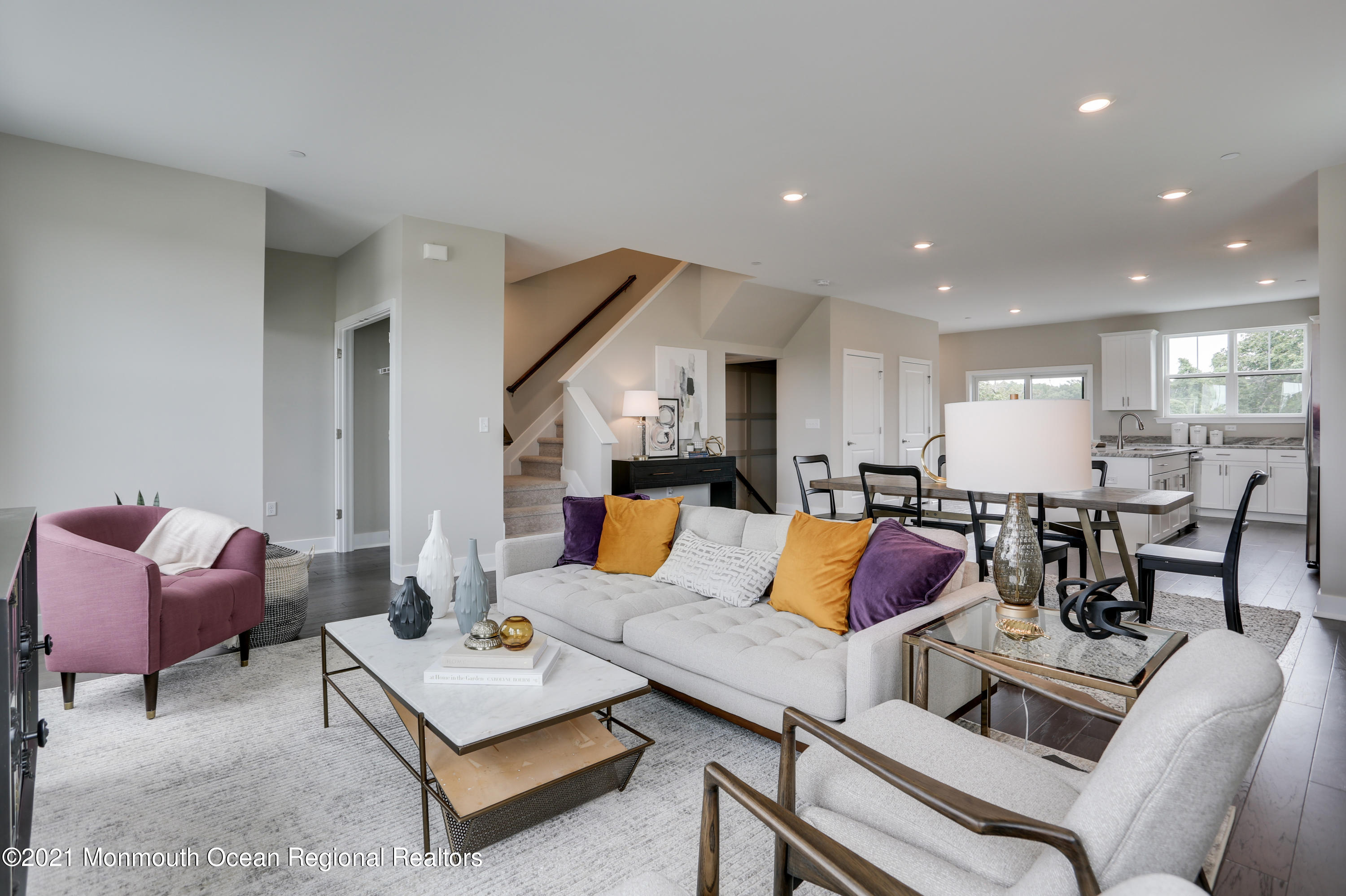 a living room with furniture and kitchen view