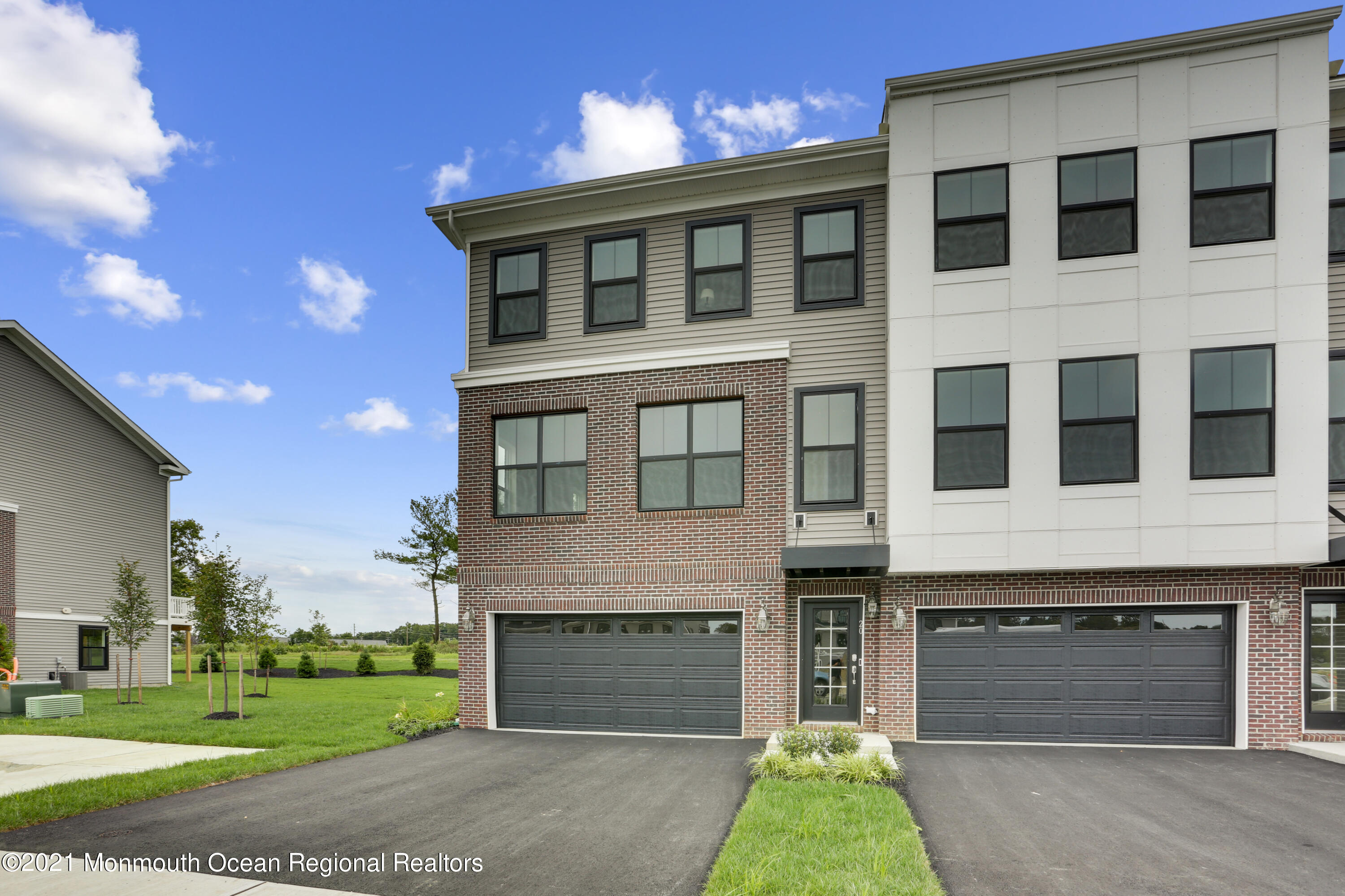 39 Mariveles Way Tinton Falls, NJ 07724 - Photo 9 of 16 a front view of a house with a yard and garage