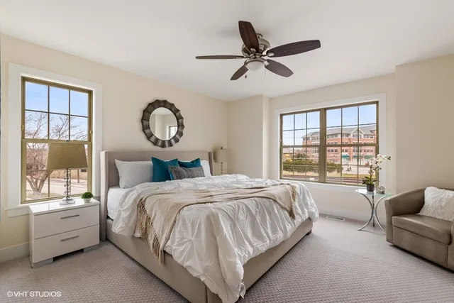 a bedroom with a bed couch and window