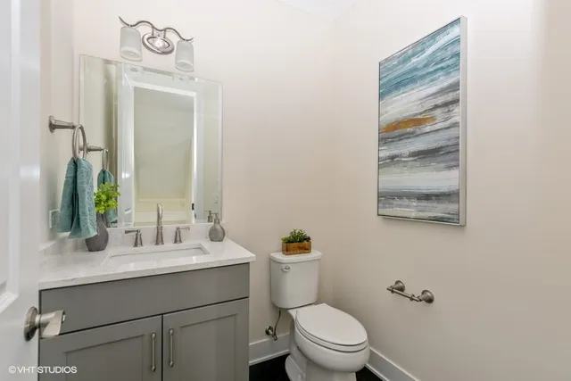a bathroom with a toilet a sink and a mirror