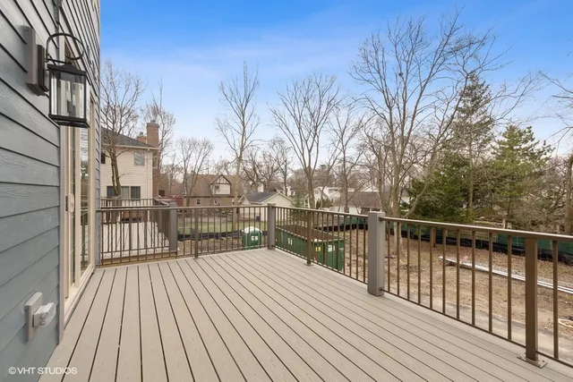 a view of a balcony with wooden floor and fence