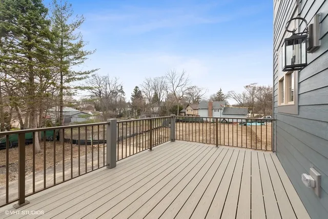 a balcony with wooden floor and fence