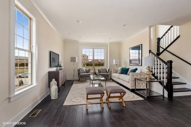 a living room with furniture flat screen tv and wooden floor