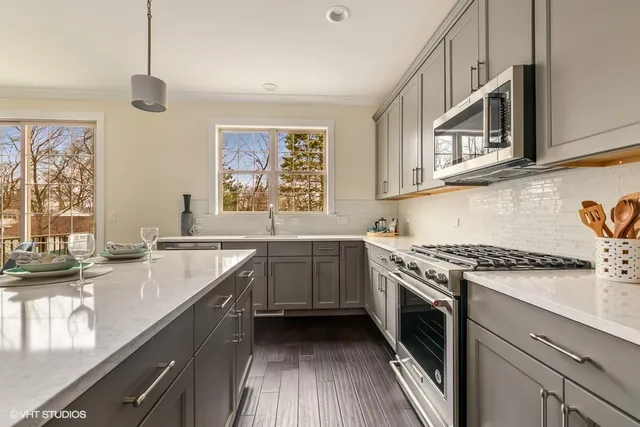 a kitchen with a sink stove and cabinets