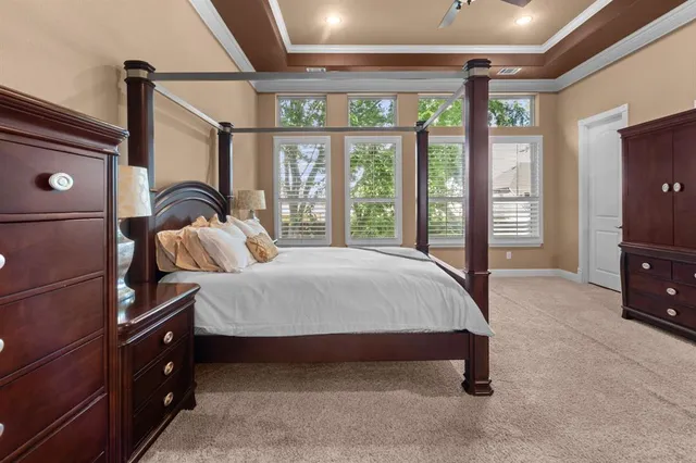 a spacious bedroom with a bed and large windows