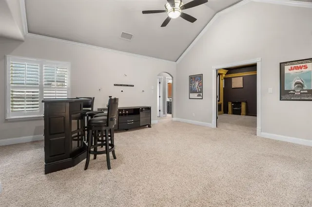a view of a livingroom with furniture and a ceiling fan