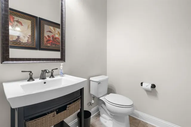 a bathroom with a toilet a sink and mirror