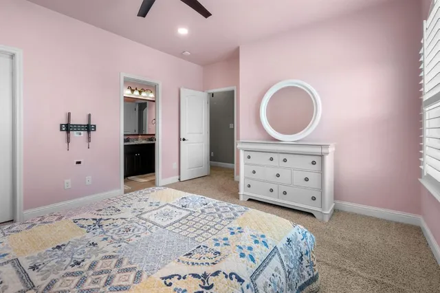 a bedroom with a bed and a dresser