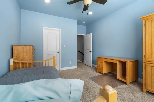 a bedroom with a bed and ceiling fan