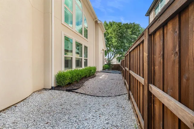 a view of a house with wooden fence