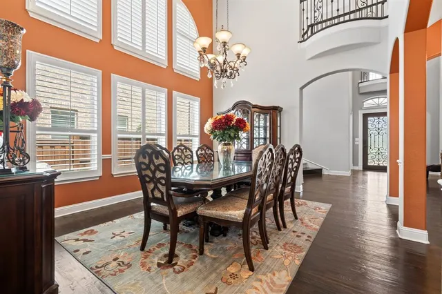 a view of a dining room with furniture a chandelier and wooden floor