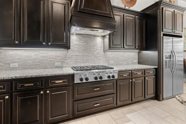 a kitchen with granite countertop stainless steel appliances and cabinets