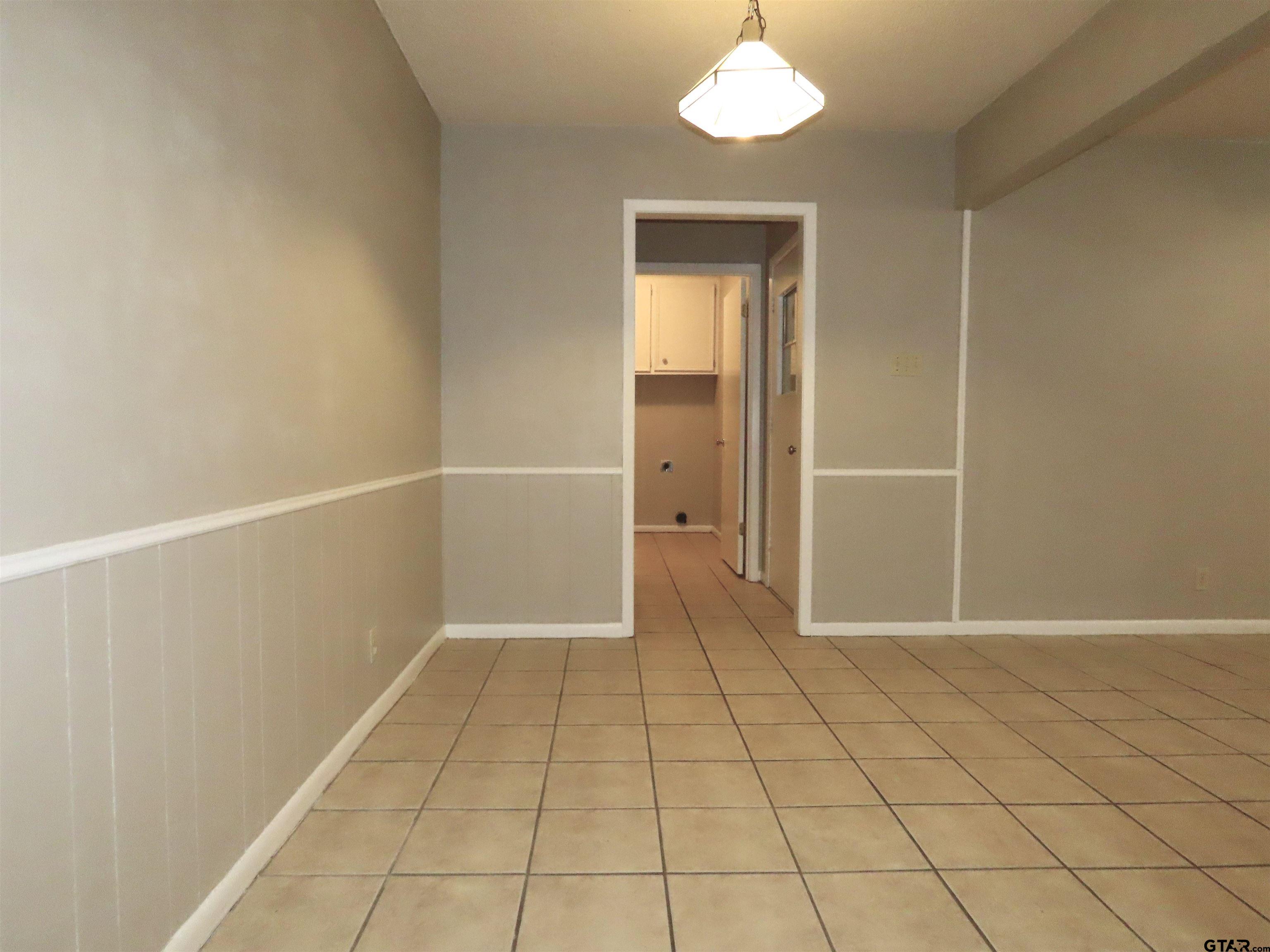 402 Muller Garden Road Tyler, TX 75703 - Photo 13 of 33 an empty room with white walls and tiles