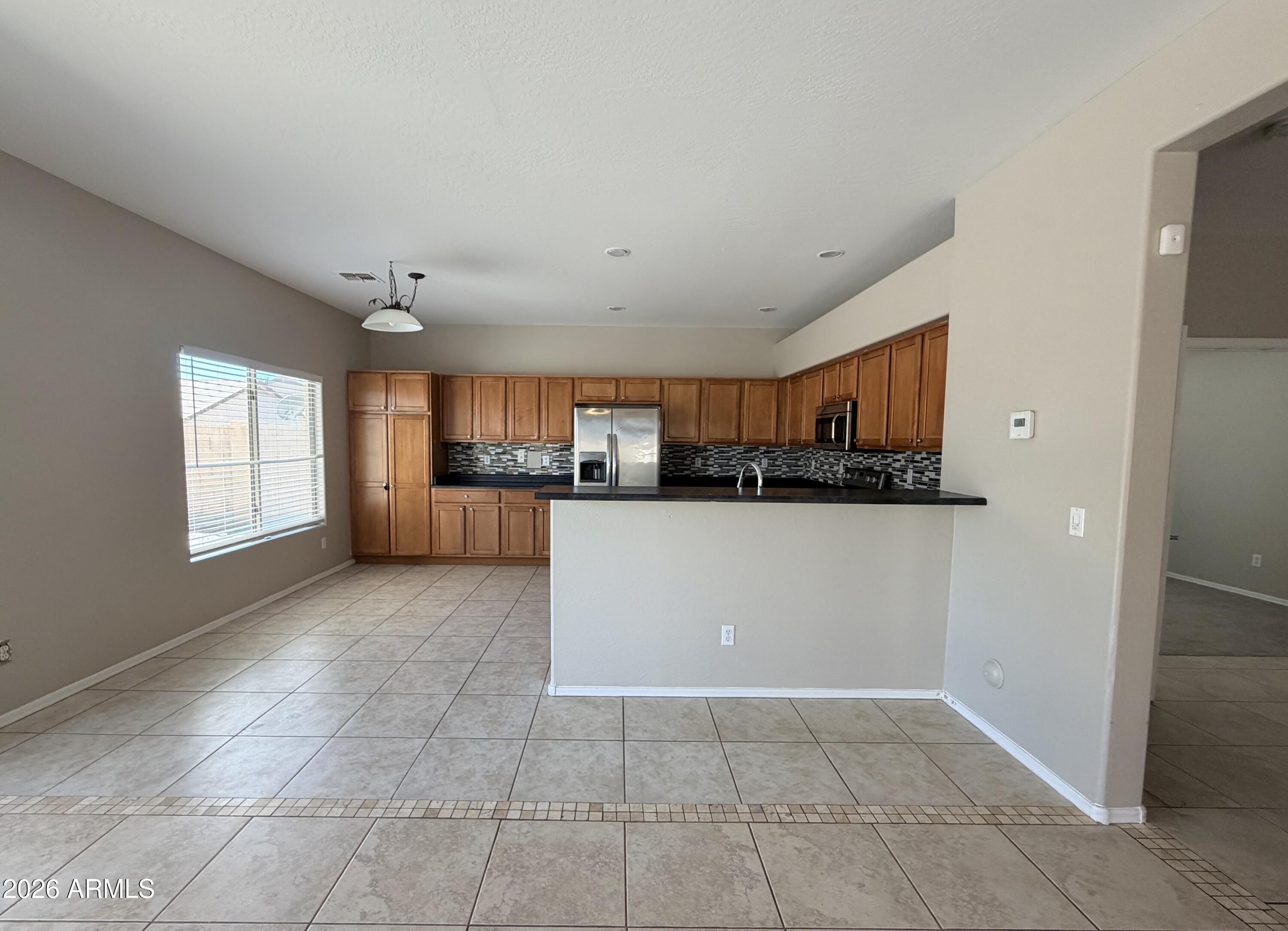 191 West Rio Drive Casa Grande, AZ 85122 - Photo 12 of 34 a view of a kitchen with an empty space and a window